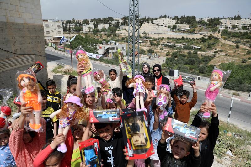 Palestinian children with toys given to celebrate Eid Al Fitr in the West Bank. EPA