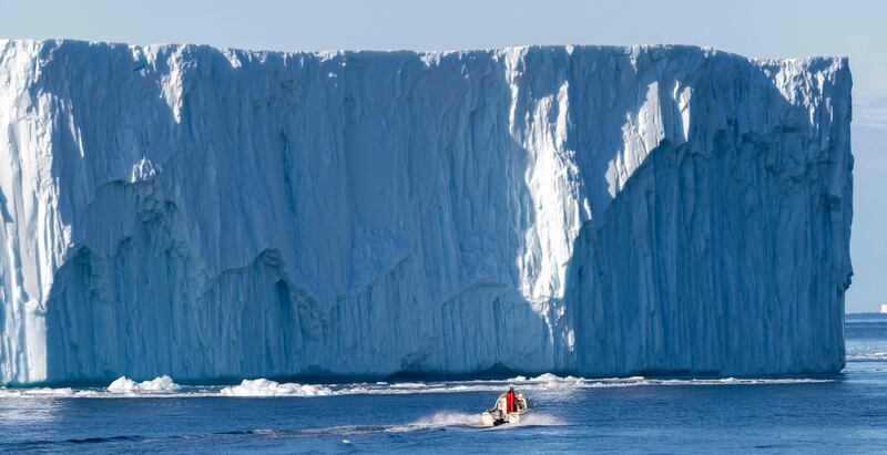 A boat manoeuvres among icebergs floating in Disko Bay, western Greenland. AFP