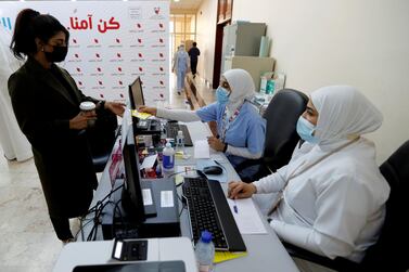 A woman takes her appointment for a second dose of a Covid-19 vaccine, at Bahrain International Exhibition & Convention Centre, in Manama, Bahrain, on December 24, 2020. Reuters