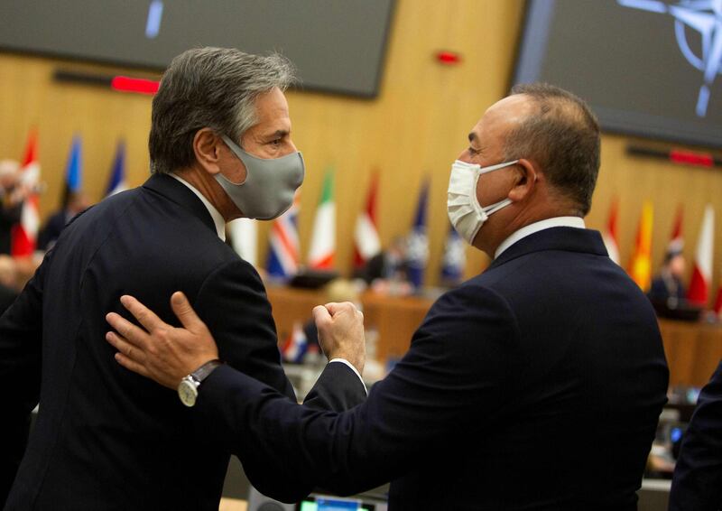 U.S. Secretary of State Antony Blinken (L) greets Turkish Foreign Minister Mevlut Cavusoglu prior to a Nato foreign ministers meeting on March 23, 2021 at the Nato headquarters in Brussels. / AFP / POOL / Virginia Mayo
