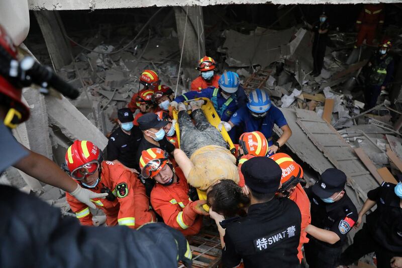 Rescue workers carry an injured woman as they search for victims after a gas pipeline explosion in Shiyan, Hubei province, China. Reuters