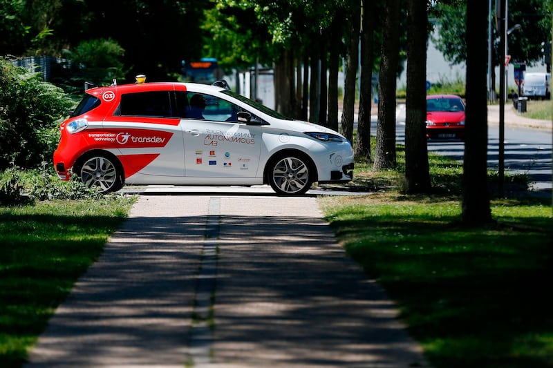 (FILES) In this file photograph taken on June 26, 2018, an autonomous car drives past during a press presentation in the north-western French city of Sotteville-lès-Rouen, near Rouen.   In the not-too-distant future, driverless cars may have to choose between saving their passengers or pedestrians when faced with unavoidable accidents. But how should they decide?. It's one of the thorniest issues faced by policymakers and manufacturers as we edge closer to a future where autonomous vehicles fill our roads, and a new study offers some potential principles based on a survey of millions of people. / AFP / CHARLY TRIBALLEAU
