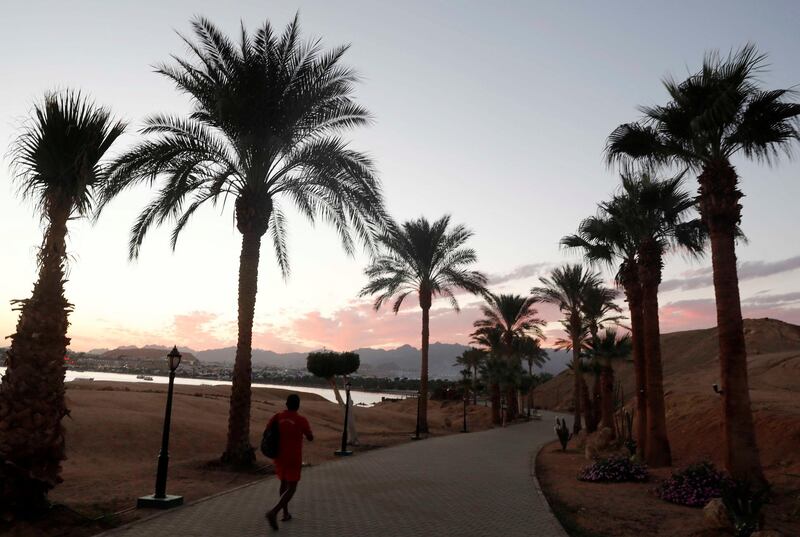 A man walks during sunset at the beach in Sharm El Sheikh, Egypt.