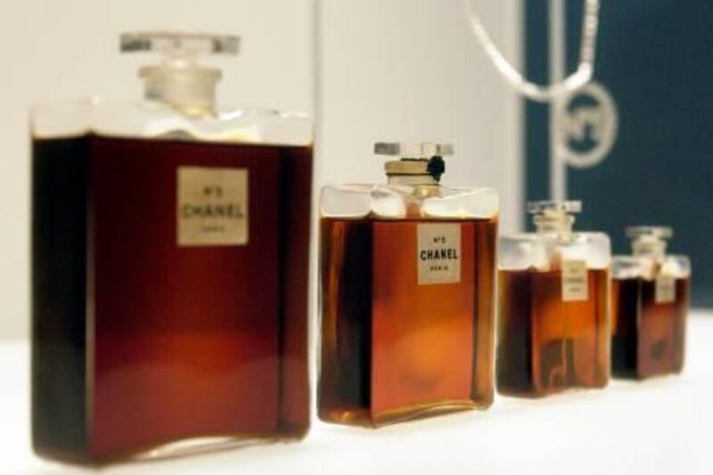 (FILES): This 02 May 2005 file photo shows four bottles of Chanel No. 5 perfume by Gabrielle Chanel from 1921, and a Chanel No. 5 necklace (R, rear) during a press preview of "Chanel", an exhibition of the history of the fashion House of Chanel at the Metropolitan Museum of Art in New York.  The US Congress reviewed testimony 27 July 2006 in Washington on whether to issue intellectual property rights to fashion houses and their creations.  AFP PHOTO/FILES/Stan HONDA