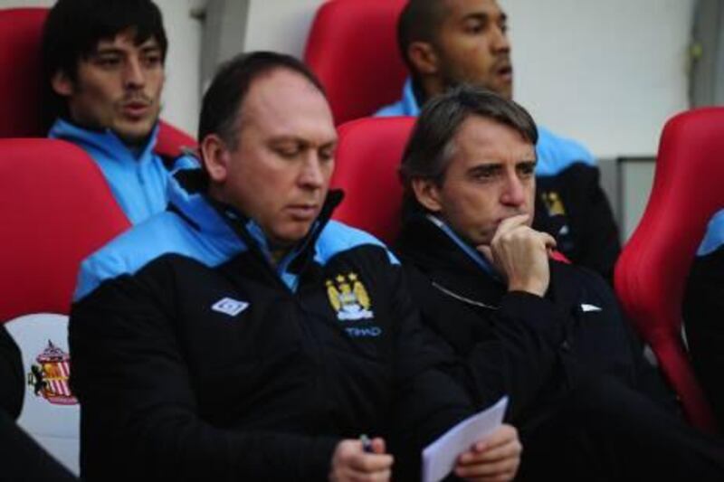 SUNDERLAND, ENGLAND - JANUARY 01: Manchester City manager Roberto Mancini (r) looks on before the Barclays Premier League match between Sunderland and Manchester City at Stadium of Light on January 1, 2012 in Sunderland, England.  (Photo by Stu Forster/Getty Images) *** Local Caption ***  136313311.jpg