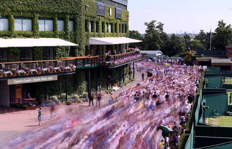 Spectators make their way into the grounds ahead of  Day 5 of The Championships - Wimbledon 2019 at All England Lawn Tennis and Croquet Club in London, England. Getty