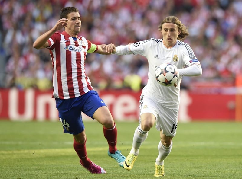 Atletico Madrid midfielder and captain Gabi, left, vies with Real Madrid midfielder Luka Modric, right, during Saturday's Champions League final. Franck Fife / AFP / May 24, 2014
