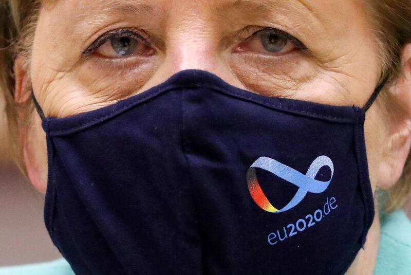 German Chancellor Angela Merkel wears a protective face mask with the logo of Germany's EU council presidency as she attends a plenary session at the European Parliament in Brussels, Belgium. Reuters