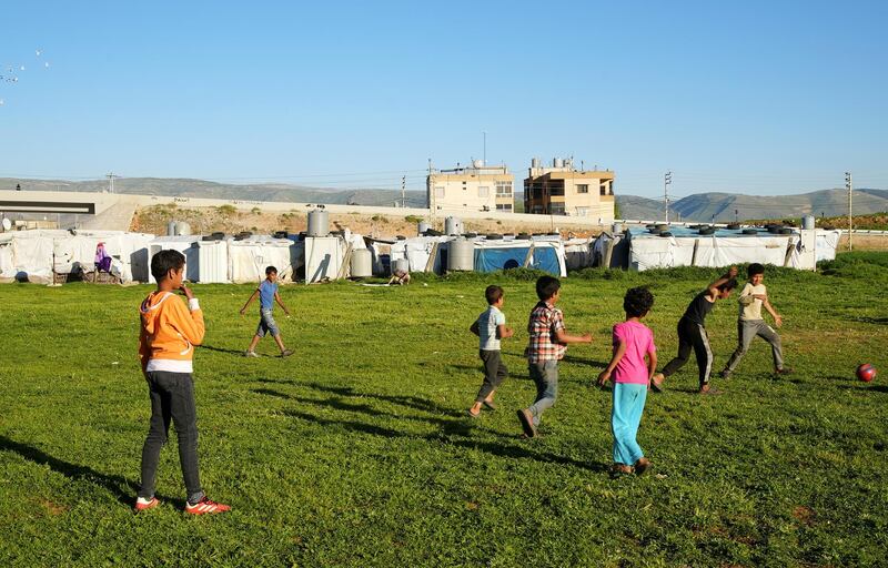 Syrian refugee youths play together at a temporary settlement in Bar Elias, in the Bekaa Valley, Lebanon. Reuters