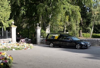 The hearse carrying the body of Queen Elizabeth II leaves the Balmoral estate on its way to Edinburgh.  EPA