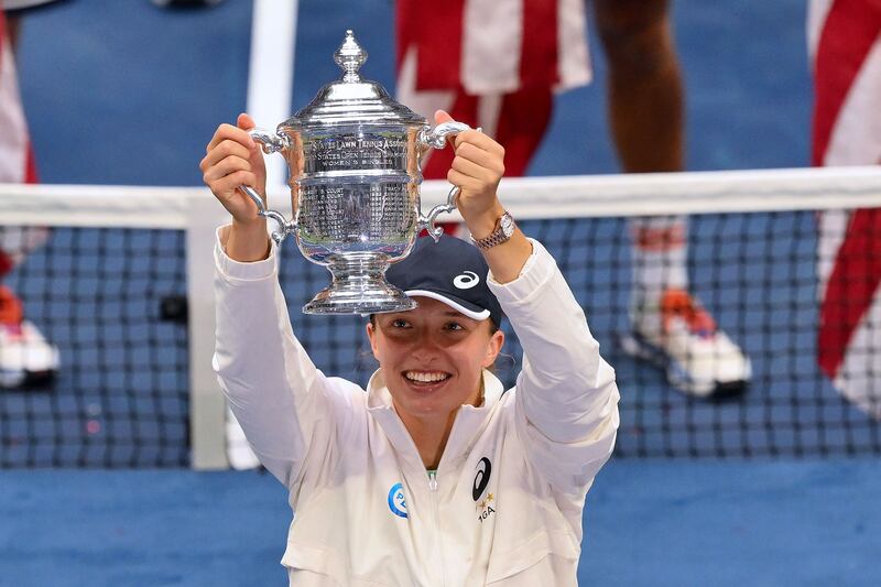 Iga Swiatek lifts the US Open trophy after winning the final against Ons Jabeur. AFP