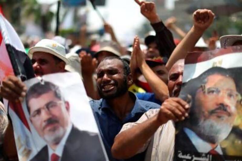 Egyptian supporters of deposed president Mohammed Morsi attend a rally supporting the former Islamist leader outside Cairo's Rabaa Al Adawiya mosque.