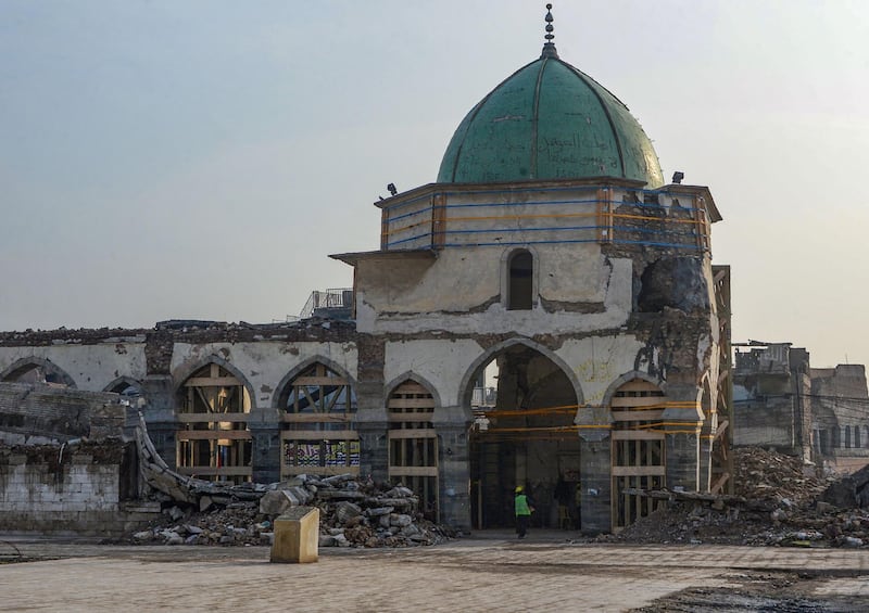 An Iraqi worker enters the Great Mosque of Al-Nuri during the complex's reconstruction in Mosul.  AFP