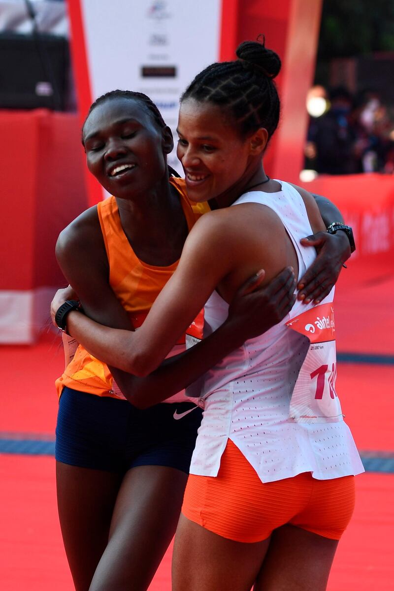 Ethiopian athlete Yalemzerf Yehualaw, right, celebrates after winning the women's 2020 Delhi Half Marathon. AFP