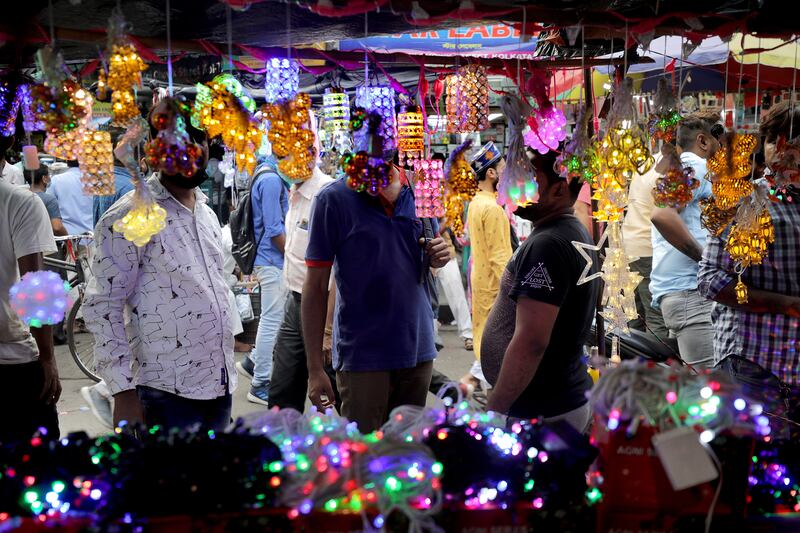 Customers visit a shop selling decorative electric lights in Kolkata. EPA