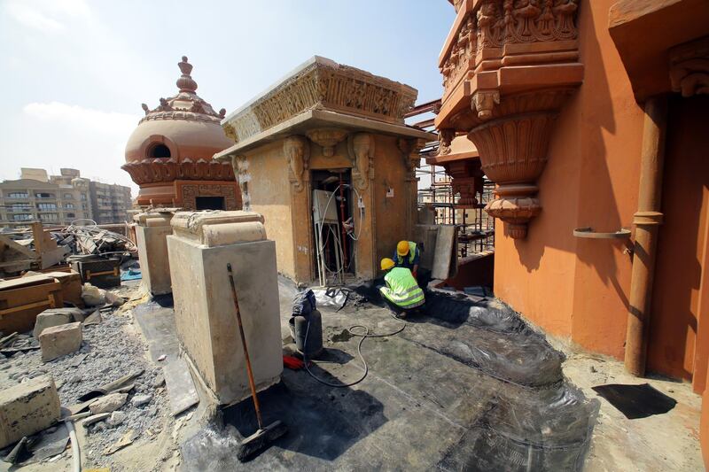 People work on the restoration of the Baron Palace during a inspection tour. EPA