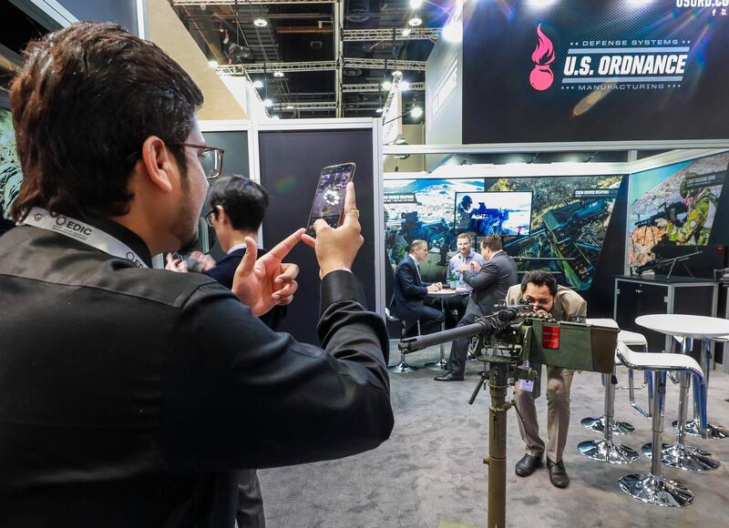 Abu Dhabi, U.A.E., February 18, 2019. INTERNATIONAL DEFENCE EXHIBITION AND CONFERENCE  2019 (IDEX) Day 2--  Exhibition visitors check out a 30mm machine gun system.rVictor Besa/The National