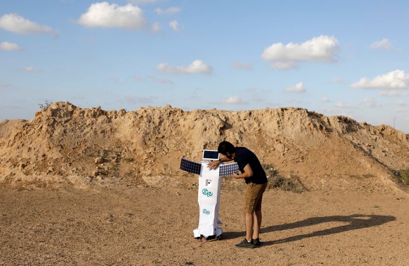 Egyptian mechatronics engineer Mahmoud El Komy, 27, checks ELU during a demonstration in Borg Al Arab desert