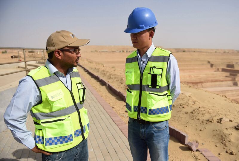 Chinese Technical Director Yan Bing Bing, right, talks with a Pakistani co-worker at an open-pit coal mining site at Islamkot in the desert in the Tharparkar district of Pakistan's southern Sindh province. AFP