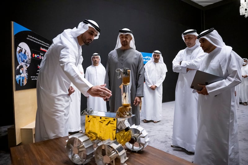 A team member introduces Sheikh Mohamed to Rashid the rover.