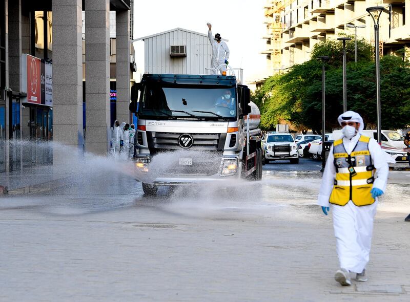 Municipality workers spray disinfectant as a precaution against the spread of coronavirus at the Kuwait Salmiya market following the outbreak of coronavirus in Kuwait.  EPA