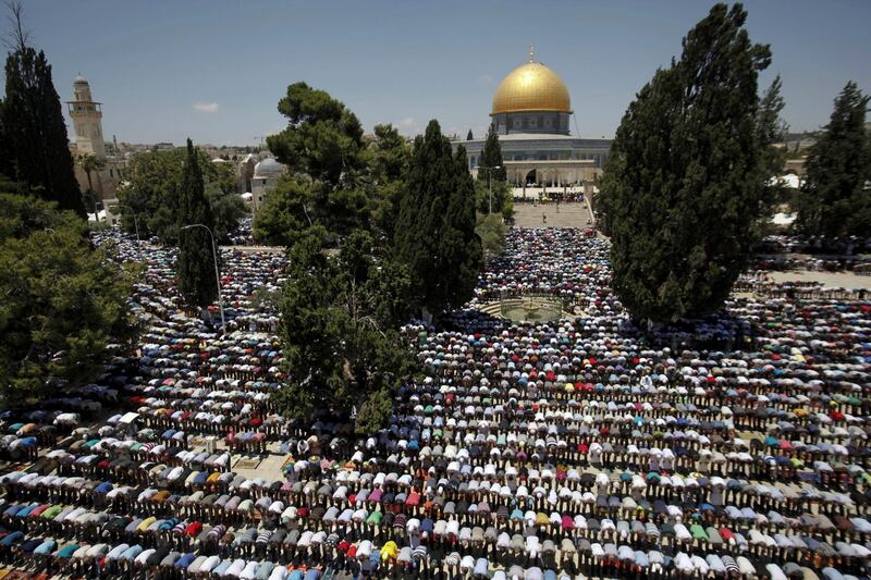 Palestinian worshippers pray in front of the Al-Aqsa Mosque in Jerusalem during the first Friday of the holy month of Ramadan, Friday, June 19, 2015. The golden Dome of the Rock shrine is seen in the background. Muslims believe Prophet Muhammad made his night journey to heaven from the site. (AP Photo/Mahmoud Illean)