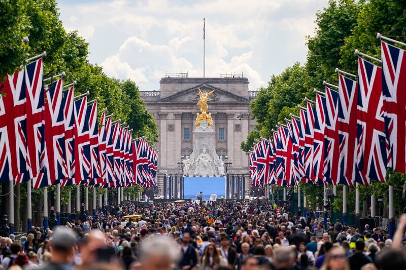 People walk along The Mall in London, before the start of the Queen's platinum jubilee weekend. AP