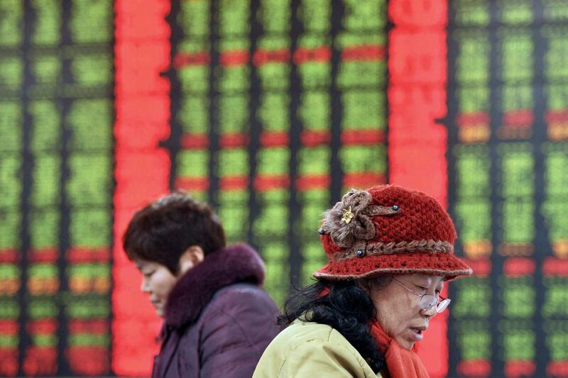 Chinese stock investors check prices at a brokerage house in Fuyang in central China's Anhui province on Thursday, January 21, 2016. Chinatopix via AP