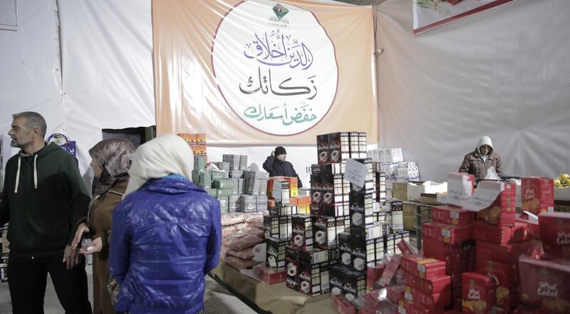 People buy government-subsidized staples at a supermarket in Damascus, Syria, as part of a campaign entitled 'Please reduce your prices'. EPA