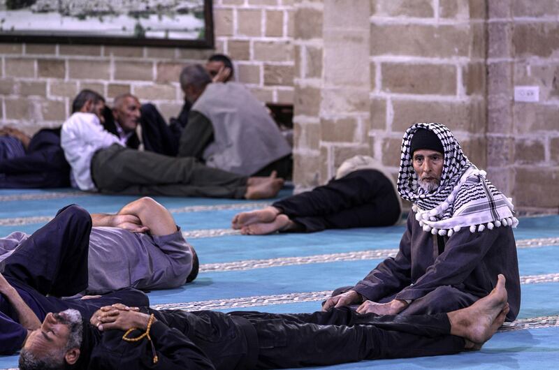 Palestinians take rest before their breakfast in Al Omari mosque in Gaza City. EPA