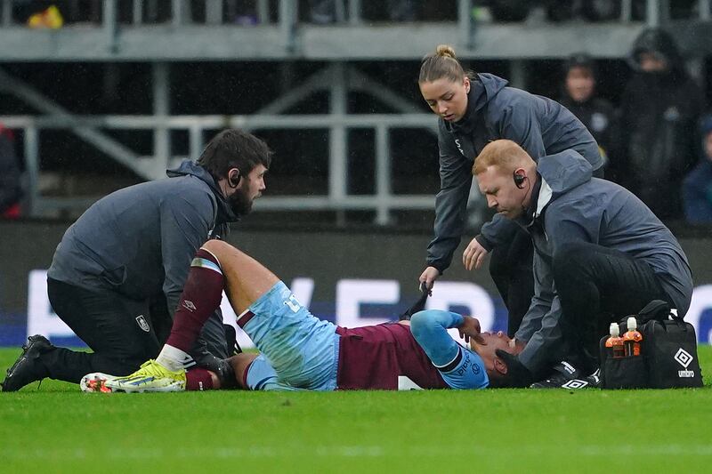 Burnley's Aaron Ramsey receives treatment for injury. PA