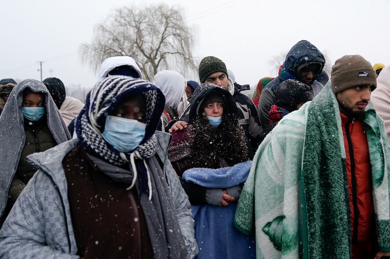 People who have fled Ukraine wait for a bus to transport them away from the border crossing in Medyka. Reuters