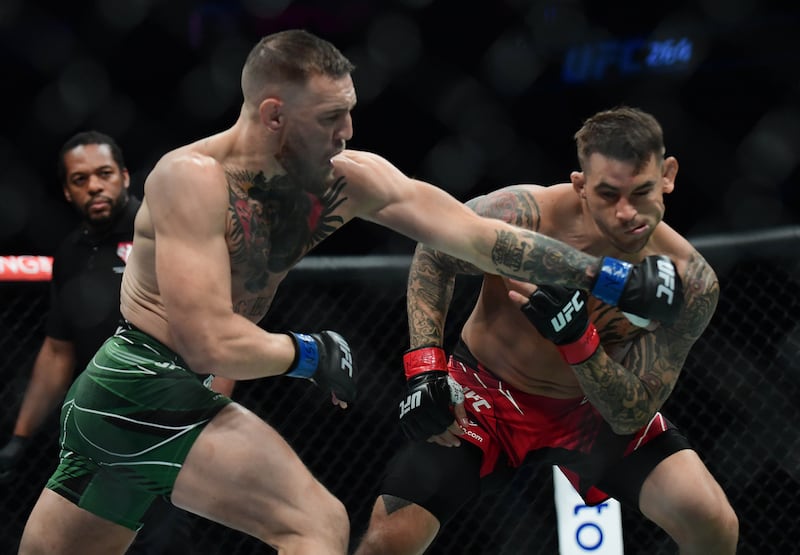 Conor McGregor moves in for a hit against Dustin Poirier during UFC 264.
