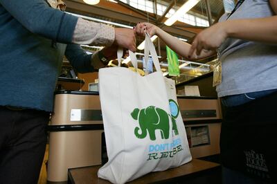 PASADENA, CA - APRIL 22:  Employees hand out free reusable grocery bags at a Whole Foods Market natural and organic foods stores which is ending the use of disposable plastic grocery bags in its 270 stores in the US Canada and UK on Earth Day, April 22, 2008 in Pasadena California. The use of reusable bags has increased since a statewide plastic bag recycling law was enacted in July 2007 requiring grocers to provide in-store plastic bag recycling and to sell reusable shopping bags. Some communities have banned disposable single-use plastic shopping bags because they don't break down in landfills, and clog waterways, endangering wildlife, and are a major source of litter.   (Photo by David McNew/Getty Images)