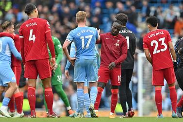 Manchester City's Belgian midfielder Kevin De Bruyne (C) shakes hands with Liverpool's Senegalese striker Sadio Mane after the English Premier League football match between Manchester City and Liverpool at the Etihad Stadium in Manchester, north west England, on April 10, 2022.  - The match ended 2-2.  (Photo by Paul ELLIS / AFP) / RESTRICTED TO EDITORIAL USE.  No use with unauthorized audio, video, data, fixture lists, club/league logos or 'live' services.  Online in-match use limited to 120 images.  An additional 40 images may be used in extra time.  No video emulation.  Social media in-match use limited to 120 images.  An additional 40 images may be used in extra time.  No use in betting publications, games or single club/league/player publications.   /  