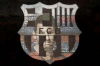 FILE PHOTO: Soccer Football - La Liga Santander - FC Barcelona v Real Sociedad - Camp Nou, Barcelona, Spain - March 7, 2020  A picture of Lionel Messi is reflected in the Barcelona emblem outside the stadium before the match   REUTERS/Albert Gea/File Photo