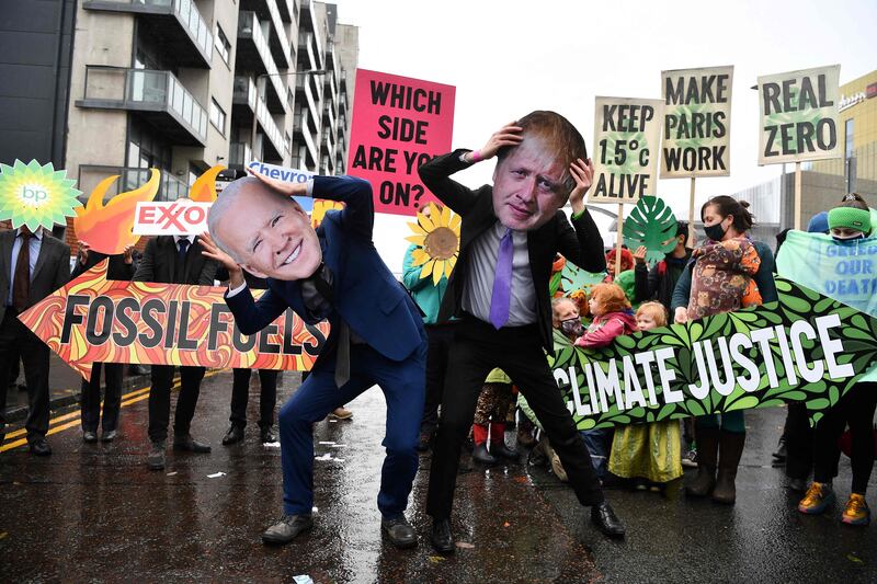 Climate activists lampoon US President Joe Biden and UK Prime Minister Boris Johnson during a protest on the sidelines of Cop26. AFP