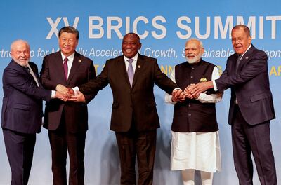 Brazilian President Luiz Inacio Lula da Silva, President of China Xi Jinping, South African President Cyril Ramaphosa, Indian Prime Minister Narendra Modi and Russia's Foreign Minister Sergei Lavrov pose for a Brics family photo during a summit in Johannesburg on August 23. The bloc has welcomed several new members this year. Reuters