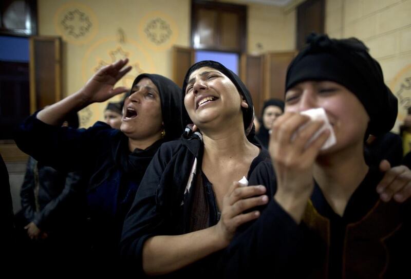 Relatives of killed Coptic Christians grieve during their funeral at Abu Garnous Cathedral in Minya, Egypt, Friday, May 26, 2017.  AP Photo/Amr Nabil