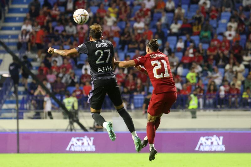 Malo Gusto and Kostas Tsimikas jump for a header in the Dubai Super Cup. AFP