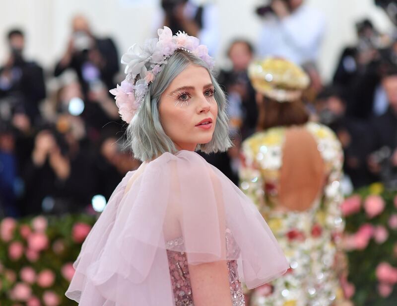 Actress Lucy Boynton dyed her choppy bob a sherbet blue, which contrasted beautifully against her pink floral headband and faux rhinestone lashes. AFP
