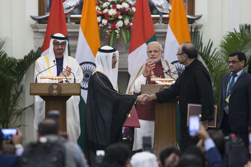 Sheikh Mohammed bin Zayed, Crown Prince of Abu Dhabi and Deputy Supreme Commander of the  Armed Forces and Narendra Modi Prime Minister of India witness the exchange of a memorandum of understanding between India and the UAE pertaining to infrastructure investments in India. Seen exchanging on behalf of the UAE is Sultan Al Mansouri, Minister of Economy. Philip Cheung / Crown Prince Court - Abu Dhabi