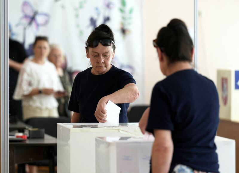 A woman casts her vote during the second round of presidential election in Panevezys, Lithuania. Reuters