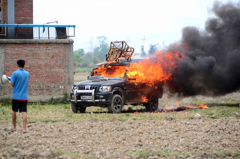 In this picture taken on May 4, 2023, smoke billows from a vehicle allegedly burned by the Meitei community tribals protesting to demand inclusion under the Scheduled Tribe category, in Imphal the capital of India's Manipur state.  (AFP)