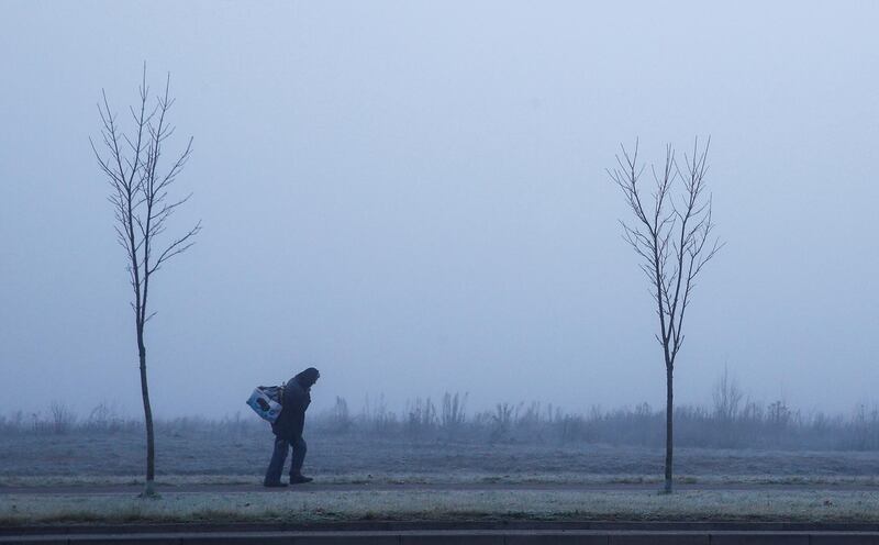 A man out walking on a foggy morning in Minsk, Belarus. Vasily Fedosenko / Reuters