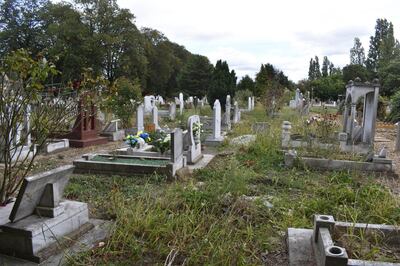 Old headstones wedged into the perimeter fence of Tottenham Park Cemetery, where local believe old graves are being dug up to make way for new burial sites. Gareth Browne / The National
