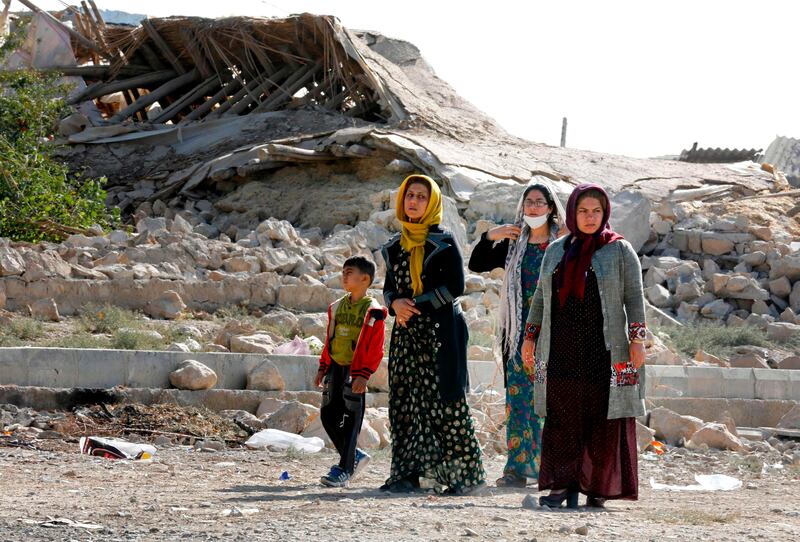 Iranians walk past the rubble of buildings in Kouik village two days after a 7.3-magnitude earthquake struck Iran's western Kermanshah province. Atta Kenare / AFP Photo
