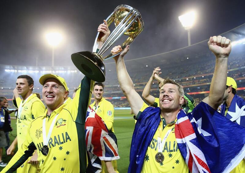 Brad Haddin and David Warner celebrate with the World Cup trophy. Ryan Pierse / Getty Images