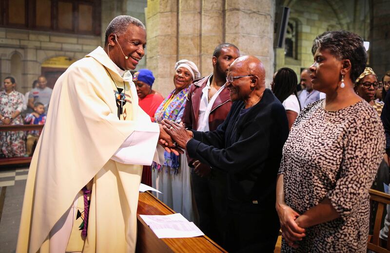 Archbishop Emeritus Desmond Tutu greets Archbishop Thabo Makgoba during Christmas Midnight Mass at St George's Cathedral in Cape Town, South Africa, in 2018. Reuters