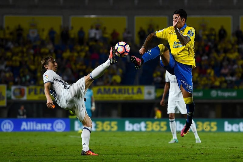 Real Madrid’s Luka Modric competes for the ball with Sergio Araujo of Las Palmas. David Ramos / Getty Images